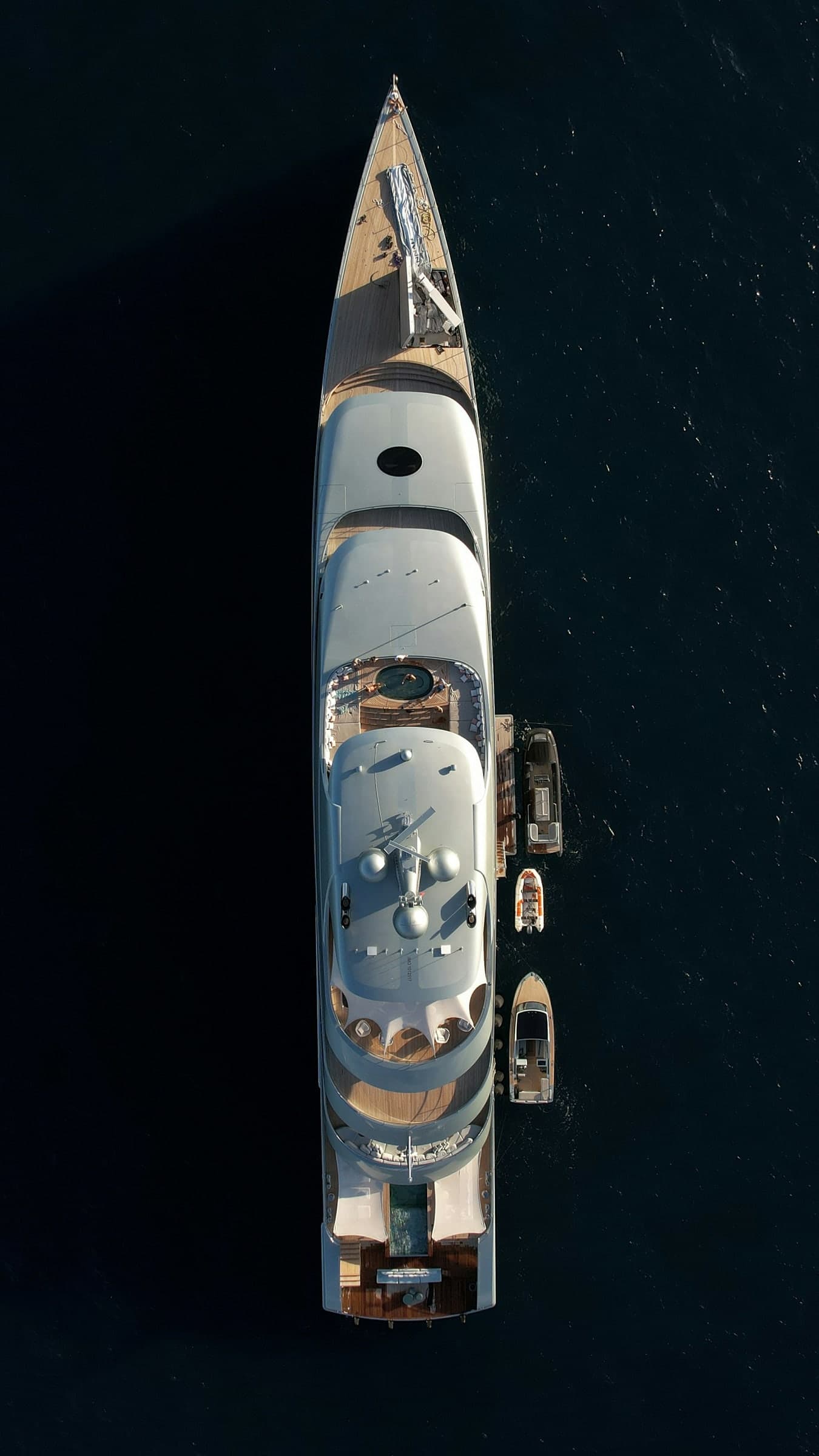 A yacht seen directly from above on dark water